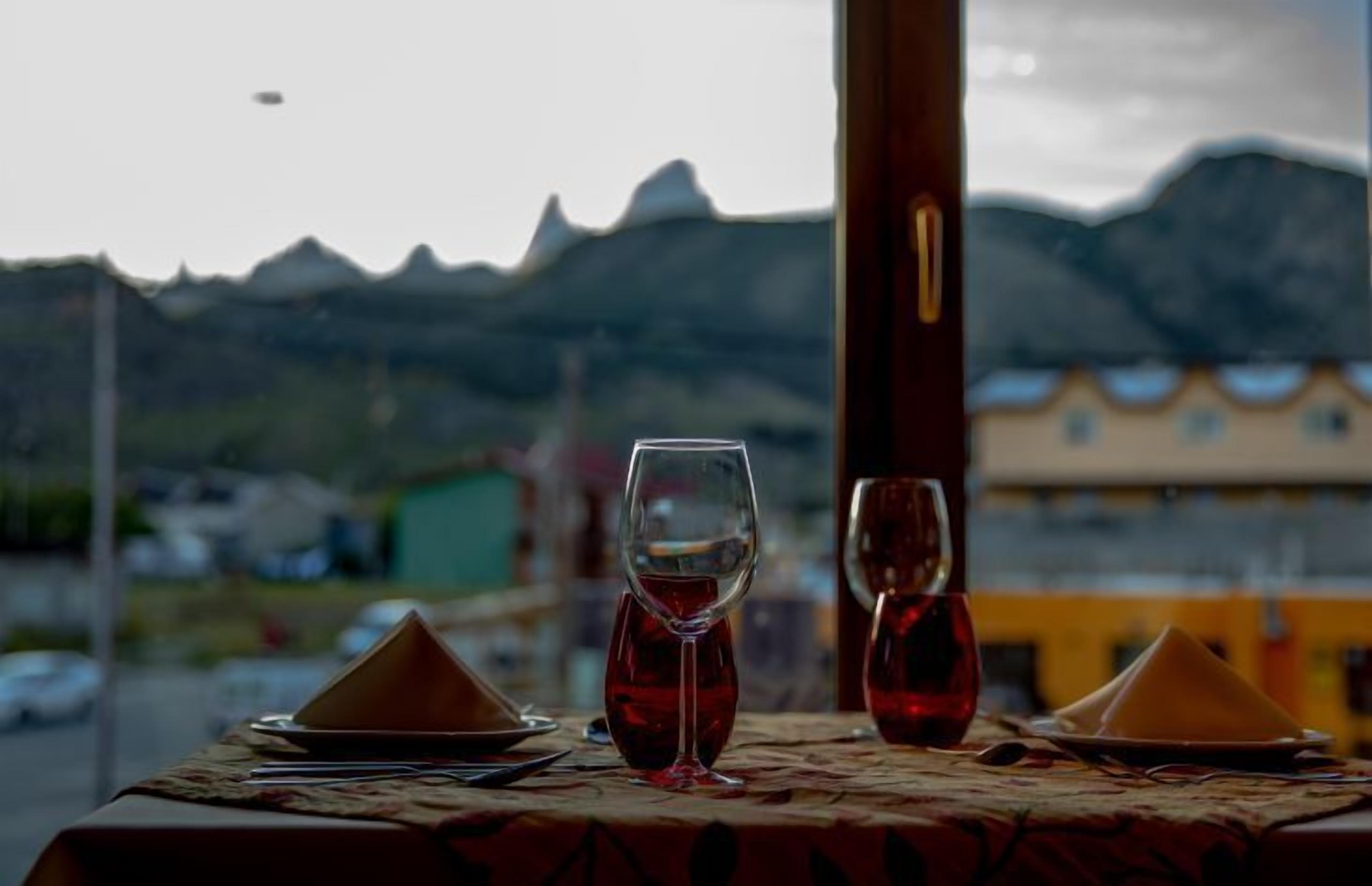 A table set for two with a mountain view in the background.