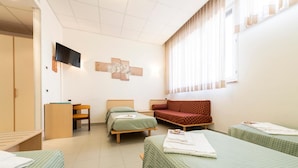 A hotel room with two single beds, a sofa, a TV mounted on the wall, and a window with blinds. - Opera Don Calabria Casa per Ferie (Rome)