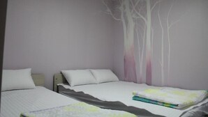 A bedroom with two beds, a wall mural, and a neutral color scheme. - Mk Liberty House (Seoul)