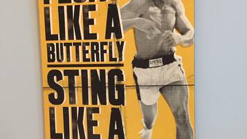A poster with a boxer and the text "FLOAT LIKE A BUTTERFLY STING LIKE A BEE".