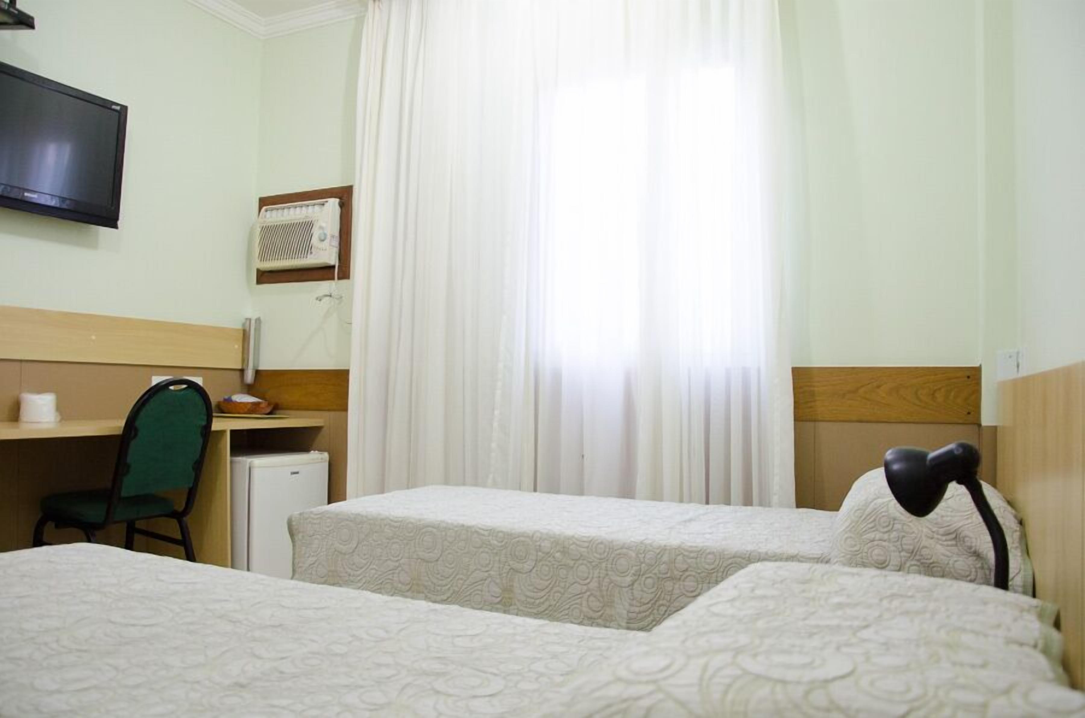 Twin Room | Minibar, in-room safe, desk, blackout drapes