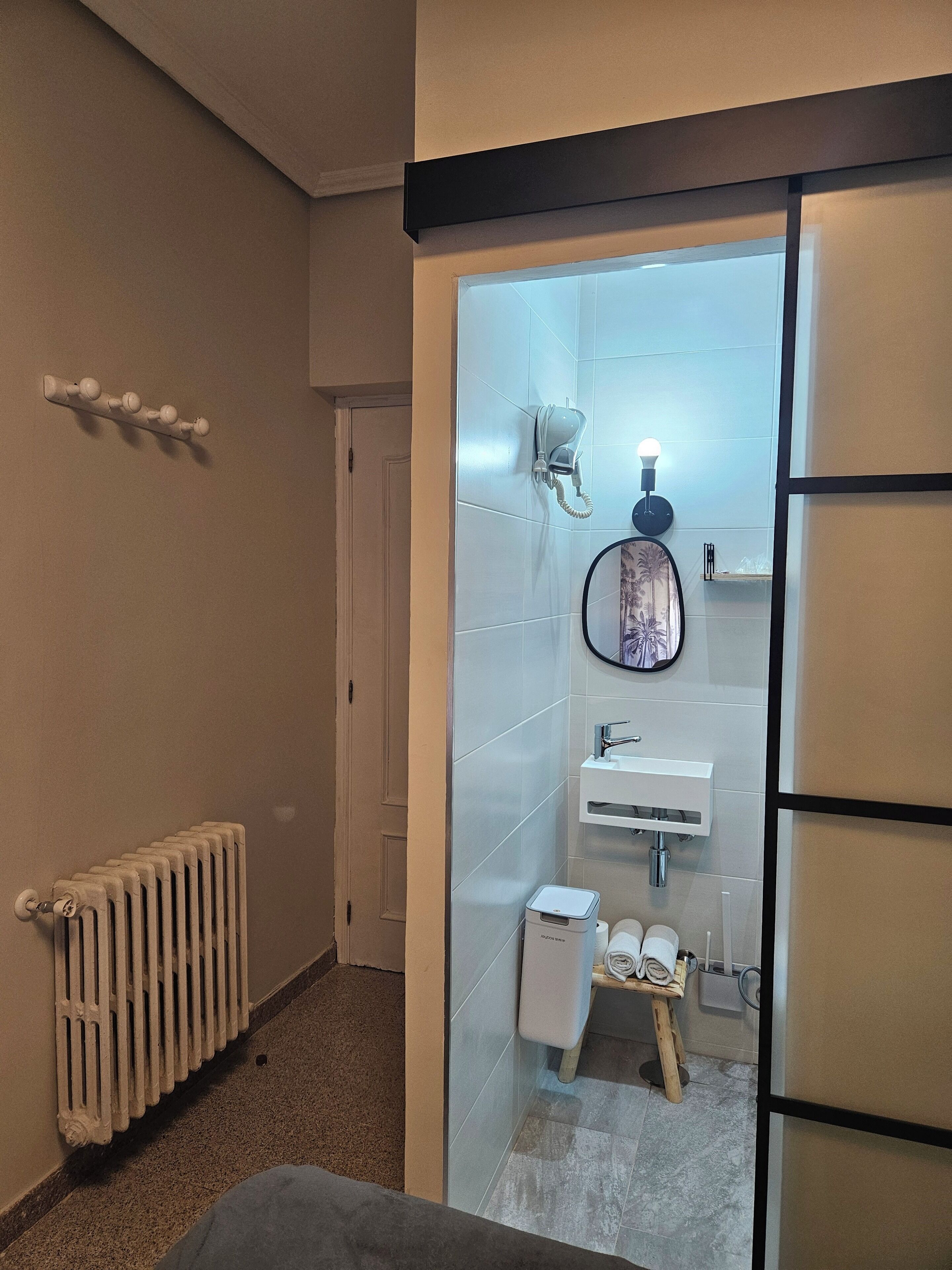 Un baño moderno con inodoro, lavabo y espejo.