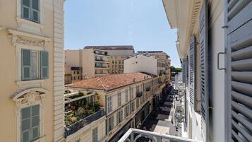 A multi-story building with balconies and a tiled roof.