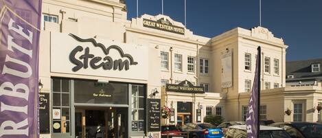 The exterior of the Great Western Hotel with a Steam restaurant entrance.