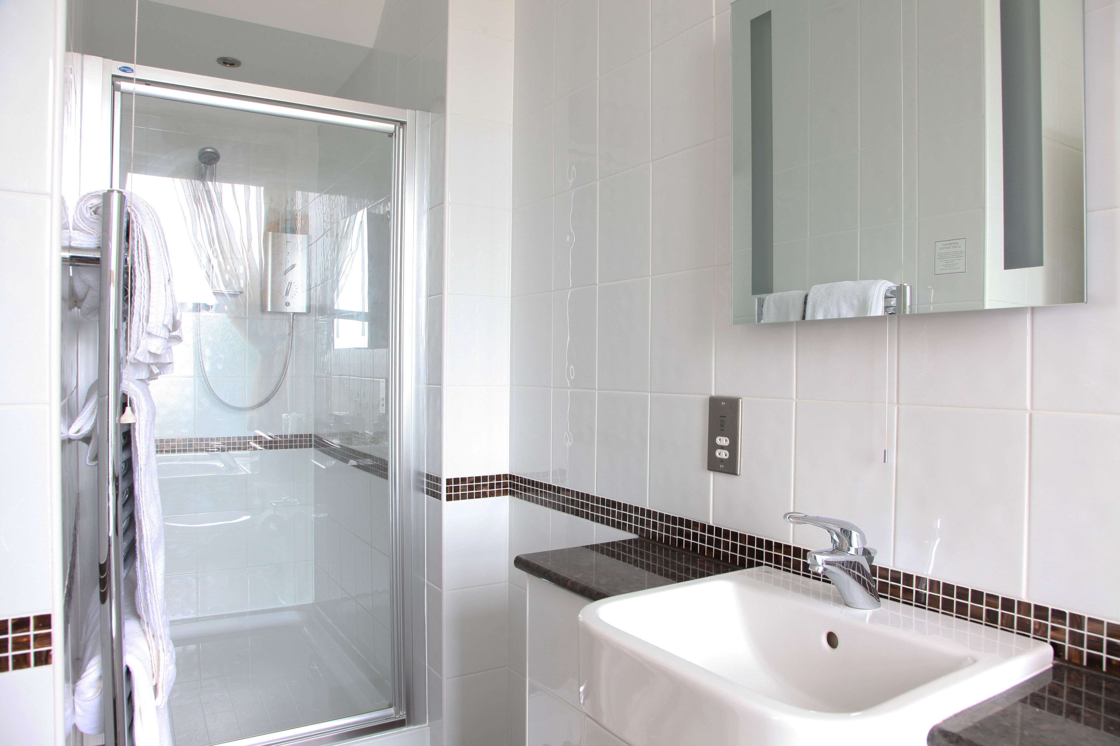 shower, designer toiletries, hair dryer, towels