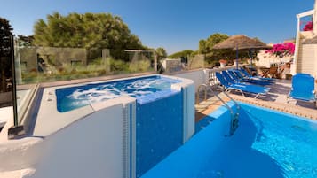 Outdoor pool, open 9 AM to 9 PM, pool umbrellas, pool loungers