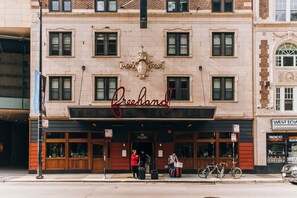 A building with a sign reading "Greenland" and a storefront with large windows. - Freehand Chicago (Chicago)