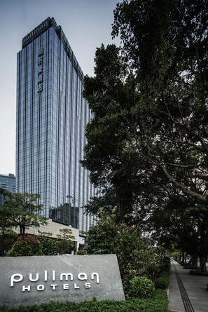 A tall, modern hotel building with a sign reading "Pullman Hotels" in front. - Pullman Zhuhai (Zhuhai)