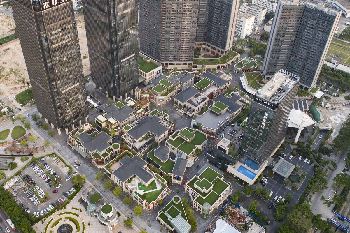 A high-rise building complex with multiple buildings, including a prominent black glass tower.