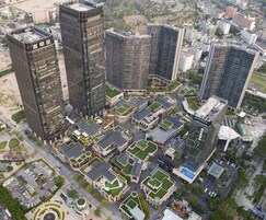 A high-rise building complex with multiple buildings, including a prominent black glass tower.