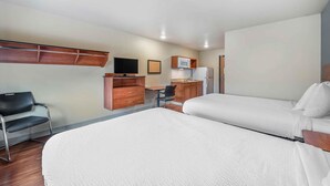 A hotel room with two beds, a desk, a chair, a television, and a kitchenette. - Extended Stay America Select Suites - Dayton - Miamisburg (Dayton)