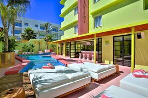 A hotel with a pool area, outdoor seating, and a bright facade. - Tropicana Ibiza Suites - Adults Only (Sant Josep de sa Talaia)