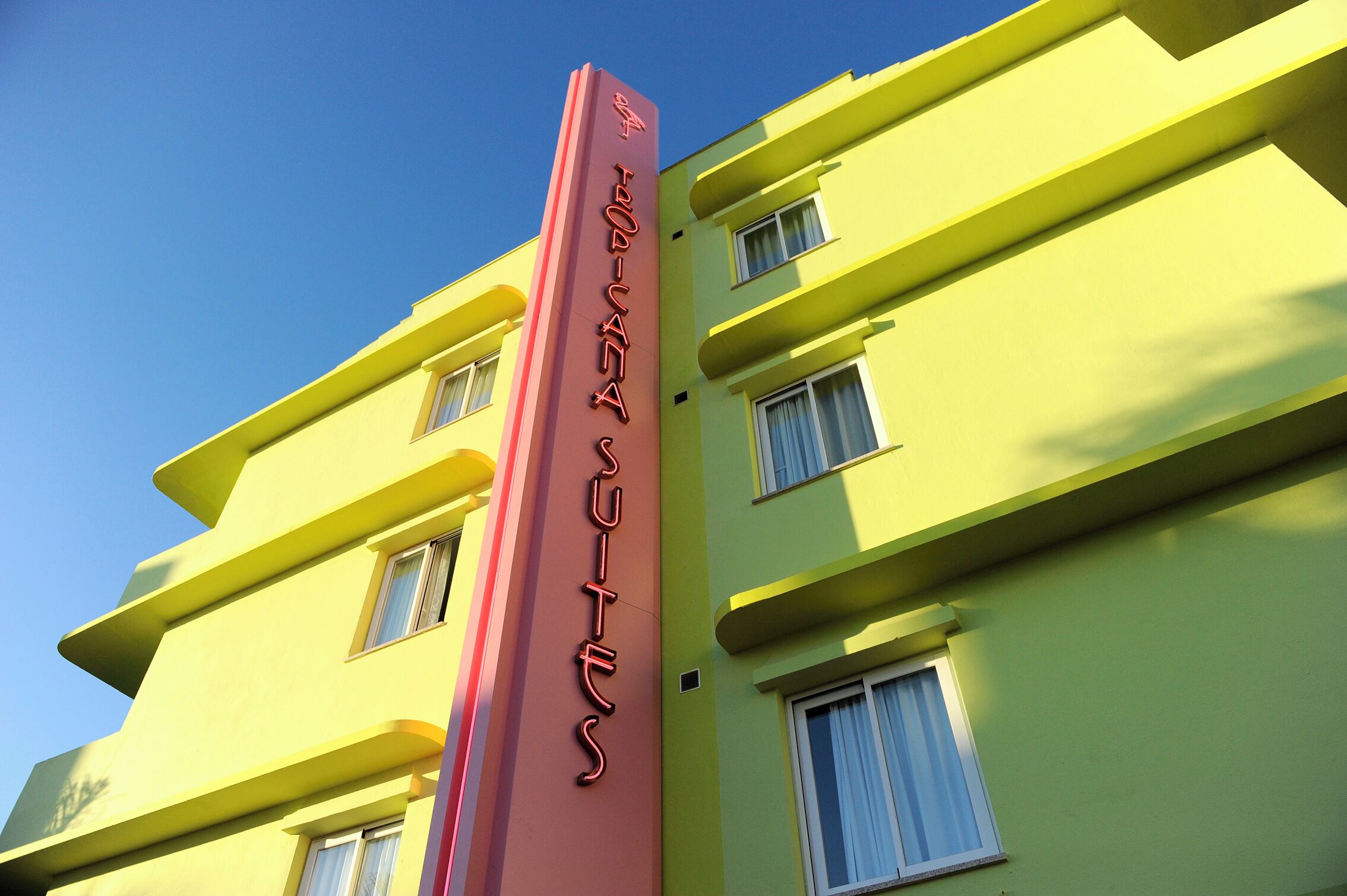 A multi-story building with a prominent vertical sign.