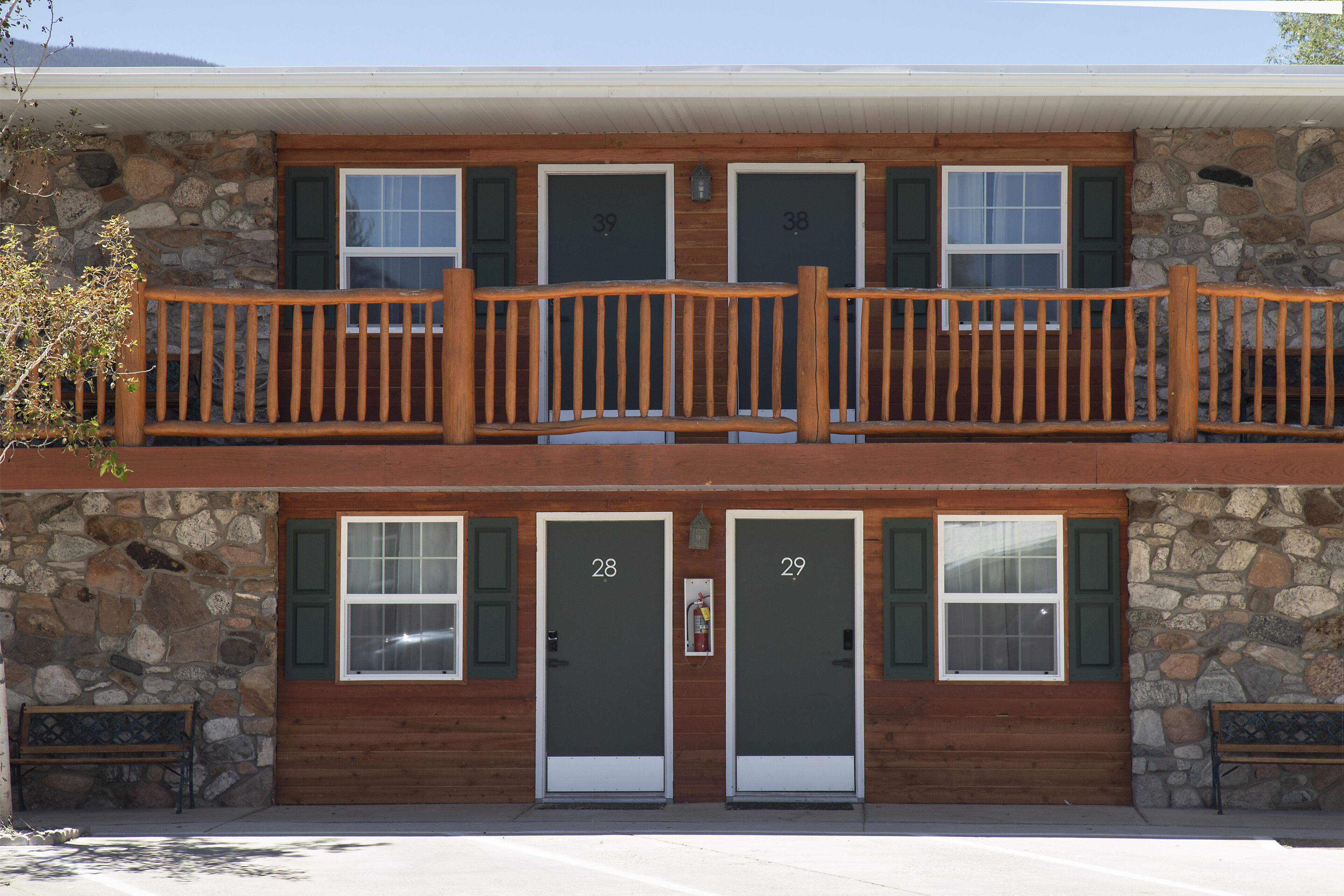 A two-story building with stone walls and wooden balconies.