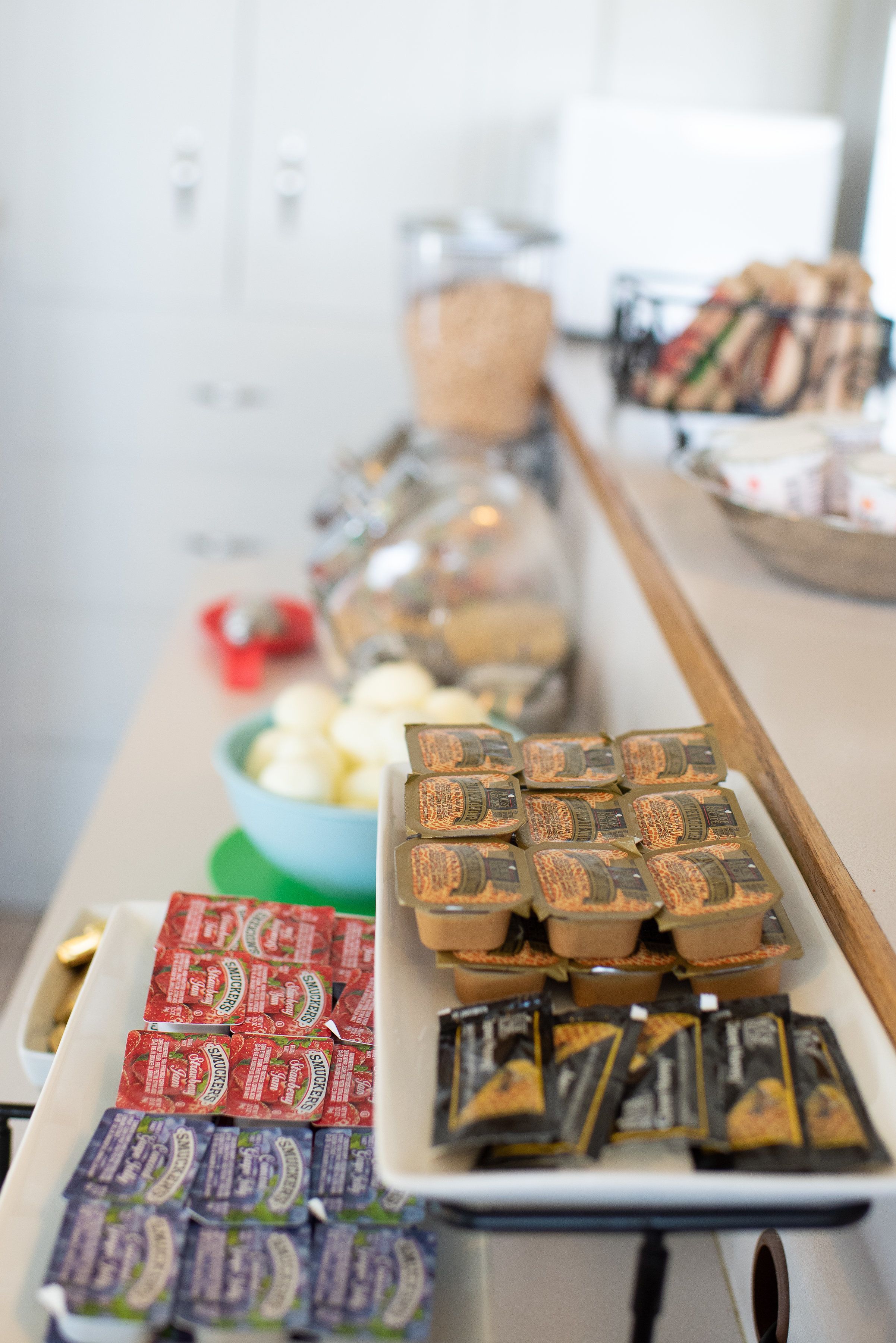 A buffet table with various food items and condiments.