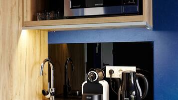 A kitchen with a microwave, coffee maker, and toaster on the countertop.