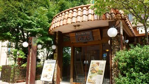 A traditional building with a tiled roof and wooden pillars, labeled "Palace Beer Village." - APA Hotel Kochi (Kochi)