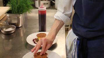 Un chef en una cocina profesional preparando un postre.