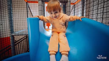 Kids can play safely within the enclosed play area featuring a fun slide.