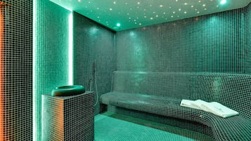 Relax in a stylish room with a geometric tile pattern, featuring a comfortable bench and a small table with a bowl.