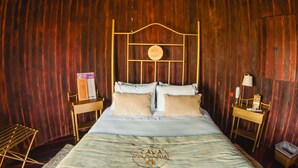 A large bed with a headboard, two bedside tables, a small table with a lamp, and a trash bin. - Hotel Cava Colchagua (Santa Cruz)