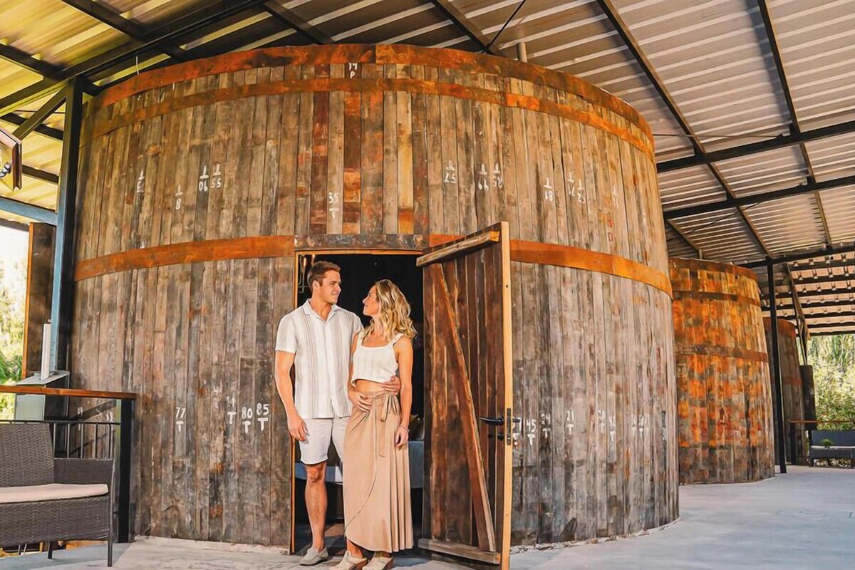 A rustic wooden structure with a circular design, possibly a barn or storage facility.