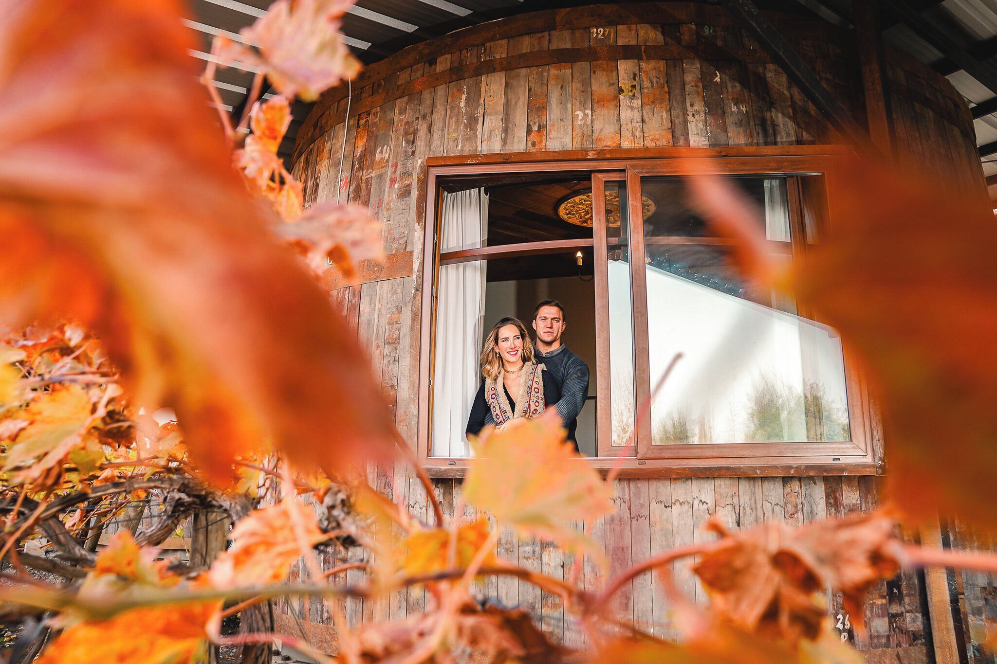 A rustic cabin with a large window and a wooden exterior.