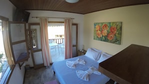 A bedroom with a bed, a painting, a window, and a door leading to a balcony. - Pousada Casa das Rosas (Búzios)