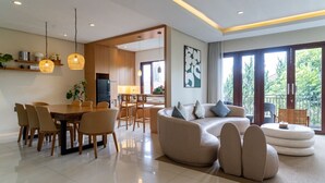A modern living room with a dining area, a kitchen, and a balcony with a view. - Breeze Blows City View 5 Br Heated Pool and a Billiard (Cimenyan)