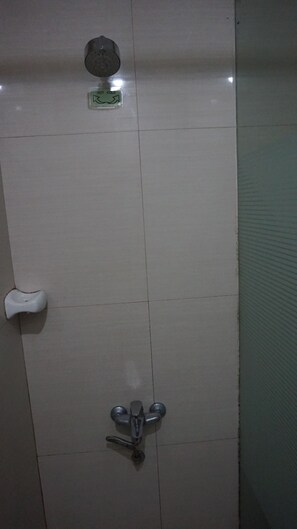 A bathroom with a white tiled wall, a hand dryer, a paper towel dispenser, and a towel rack. - Sulit Place (Quezon City)