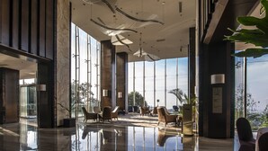 A modern lobby with a reflective floor, large windows, and contemporary furniture. - InterContinental Bandung Dago Pakar by IHG (Cimenyan)