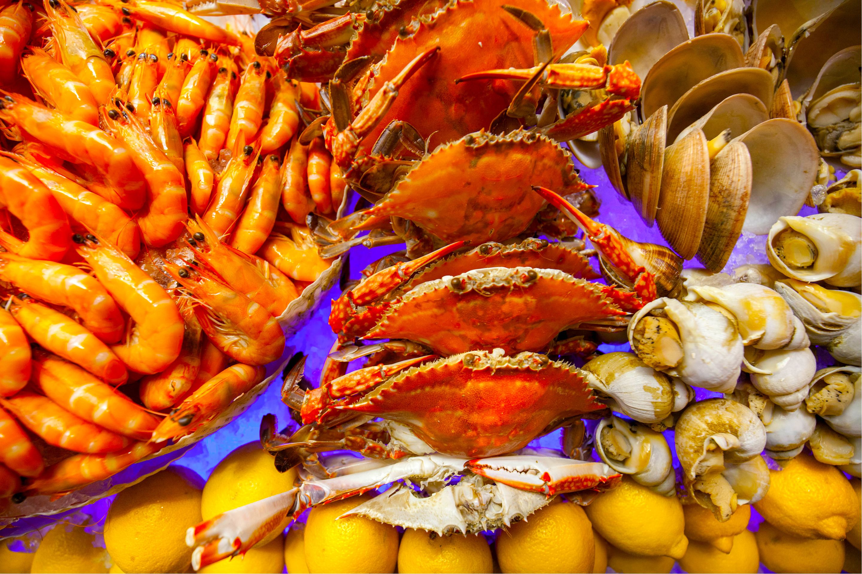 A seafood display with crabs, clams, and shrimp.