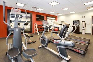 A gym with various exercise equipment, including treadmills and weight machines.