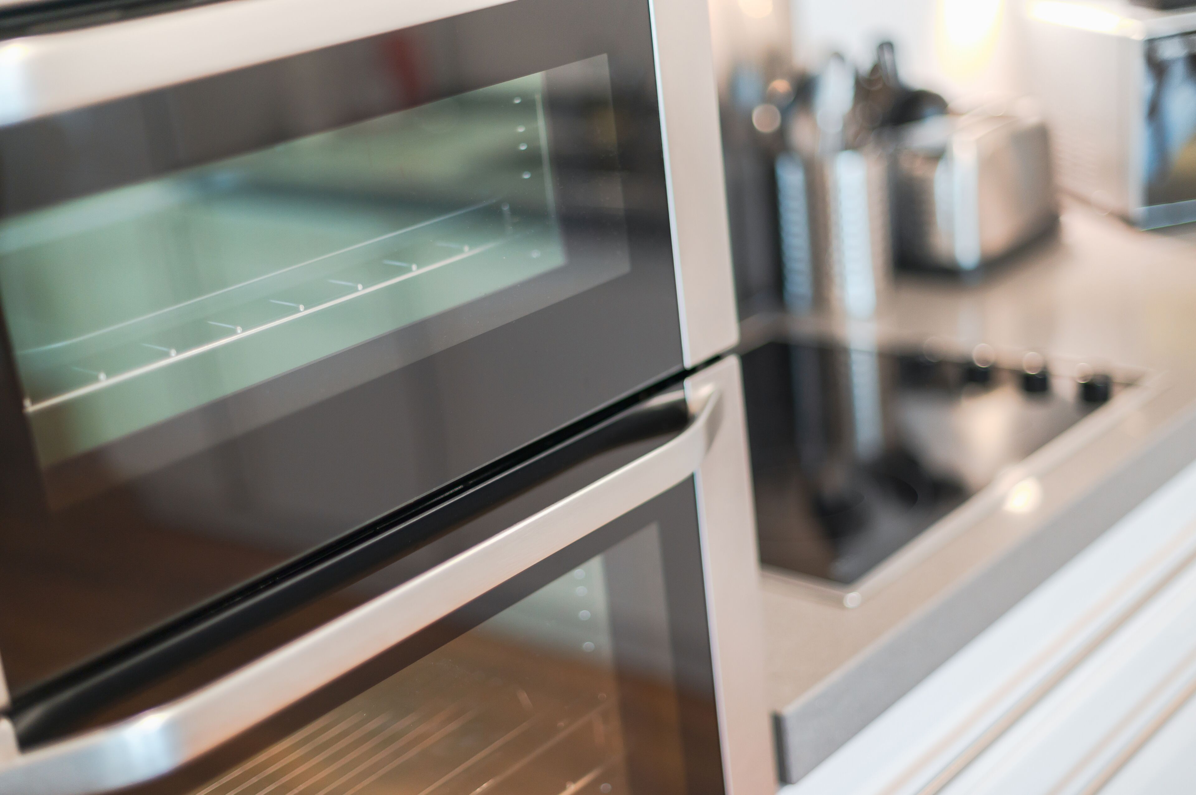 Una cocina moderna con electrodomésticos de acero inoxidable, incluyendo un horno y una estufa.