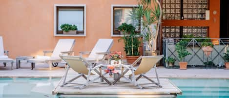 Seasonal outdoor pool, pool umbrellas, sun loungers