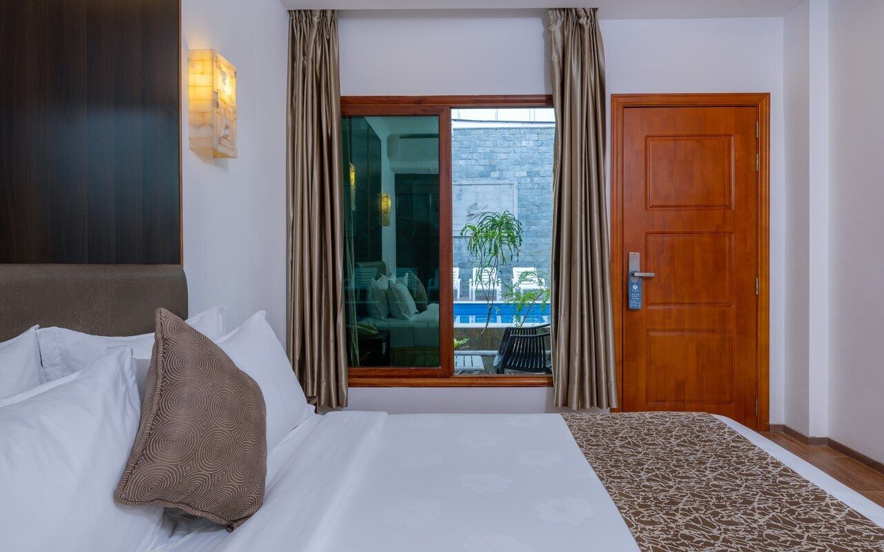 Deluxe Double Room, Pool View | Down duvets, minibar, in-room safe, individually decorated
