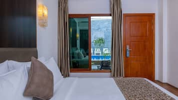 Deluxe Double Room, Pool View | Down duvets, minibar, in-room safe, individually decorated