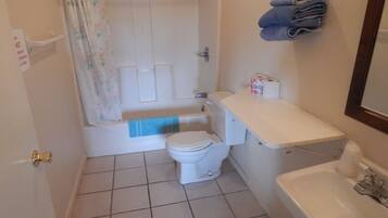 A bathroom with a toilet, sink, and bathtub.