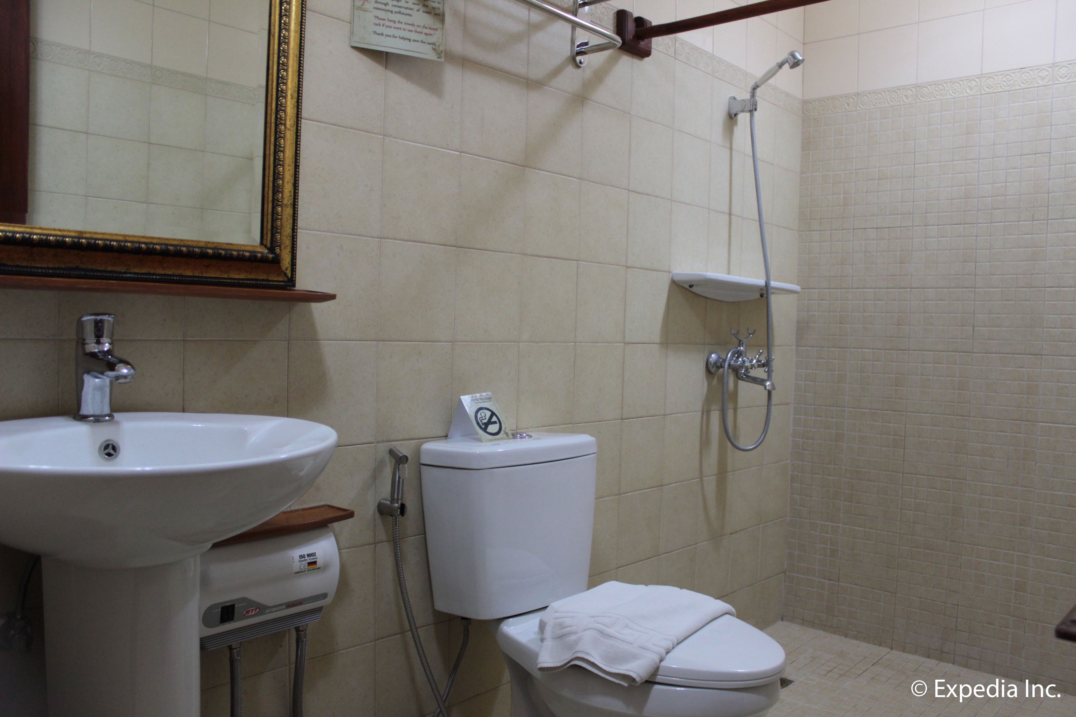 A bathroom with a sink, toilet, and shower.