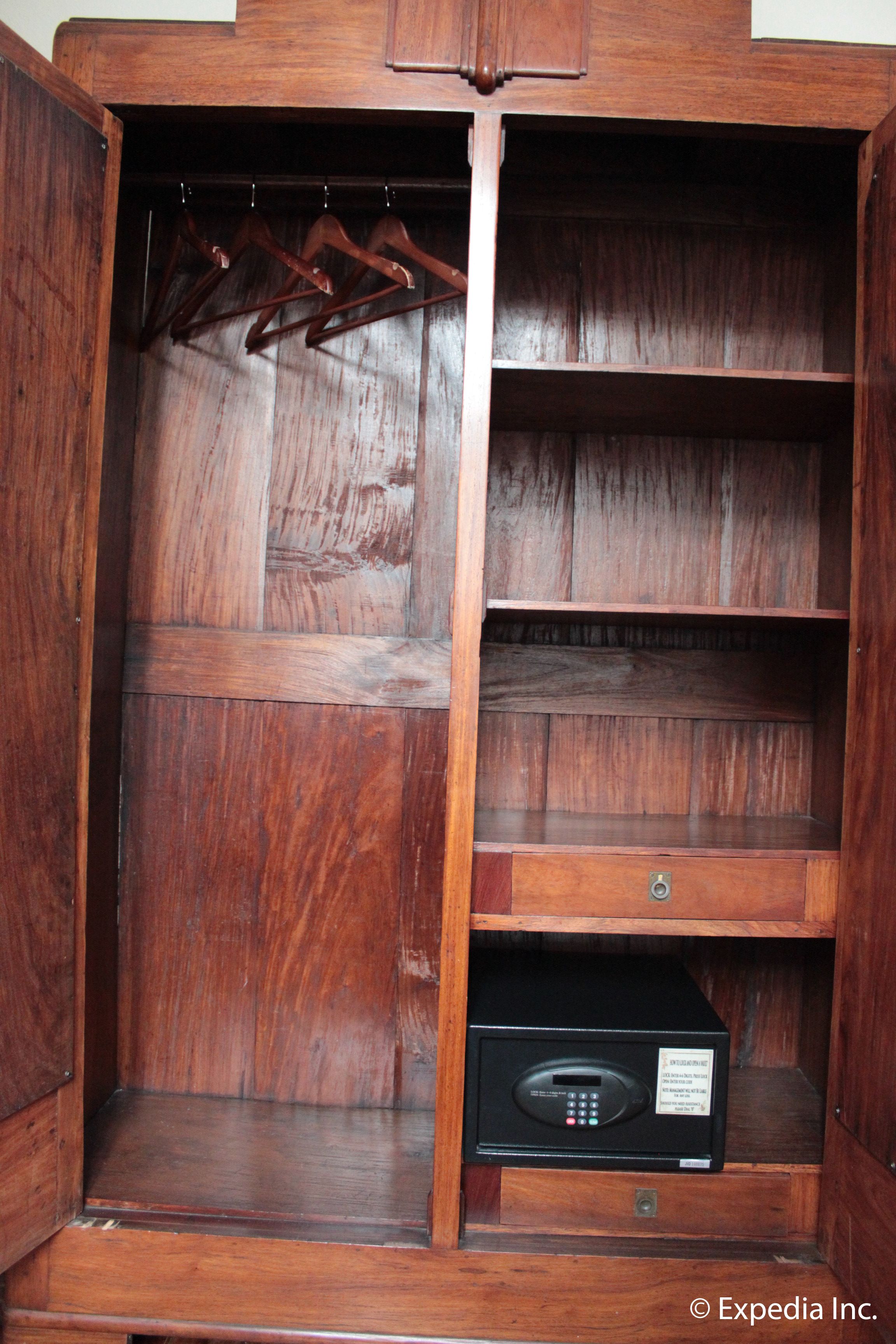 A wooden wardrobe with multiple shelves and a built-in radio.