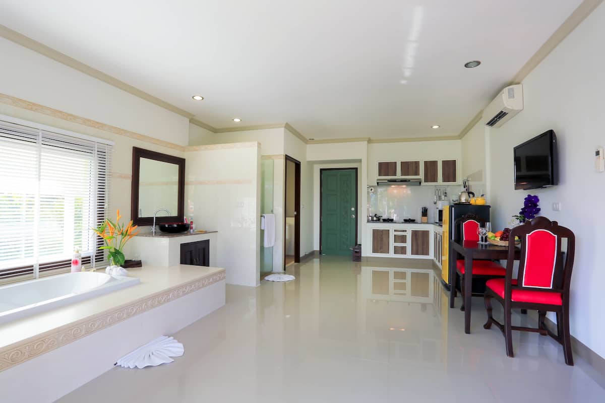 A modern kitchen with white cabinets, a built-in oven, and a microwave.