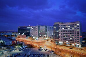A multi-story hotel with a modern design, featuring a parking lot and a street view. - Prime Guest House (Incheon)