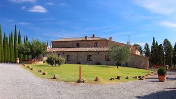 Traditional stone building with a symmetrical facade and landscaped garden.