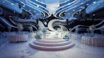 A grand, circular stage with a central platform, surrounded by tiered seating and floral arrangements.