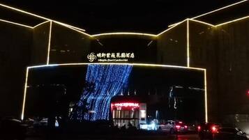 A building entrance with illuminated signage and a digital display.