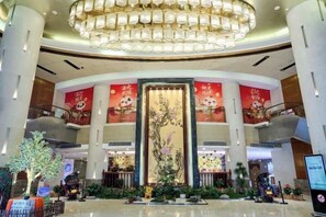 A hotel lobby with a grand chandelier, a large vertical mural, and multiple floors visible. - Mingdu Ziwei Garden Hotel (Changzhou)