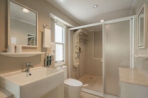 Shower, hair dryer, slippers, towels