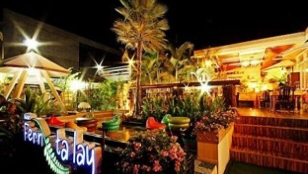 A well-lit outdoor area with a sign reading "Fern Garden". - Baan Fern Talay (Cha-am)