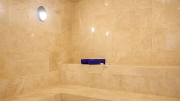 Bathroom features a shelf, bathtub, and marble floor.