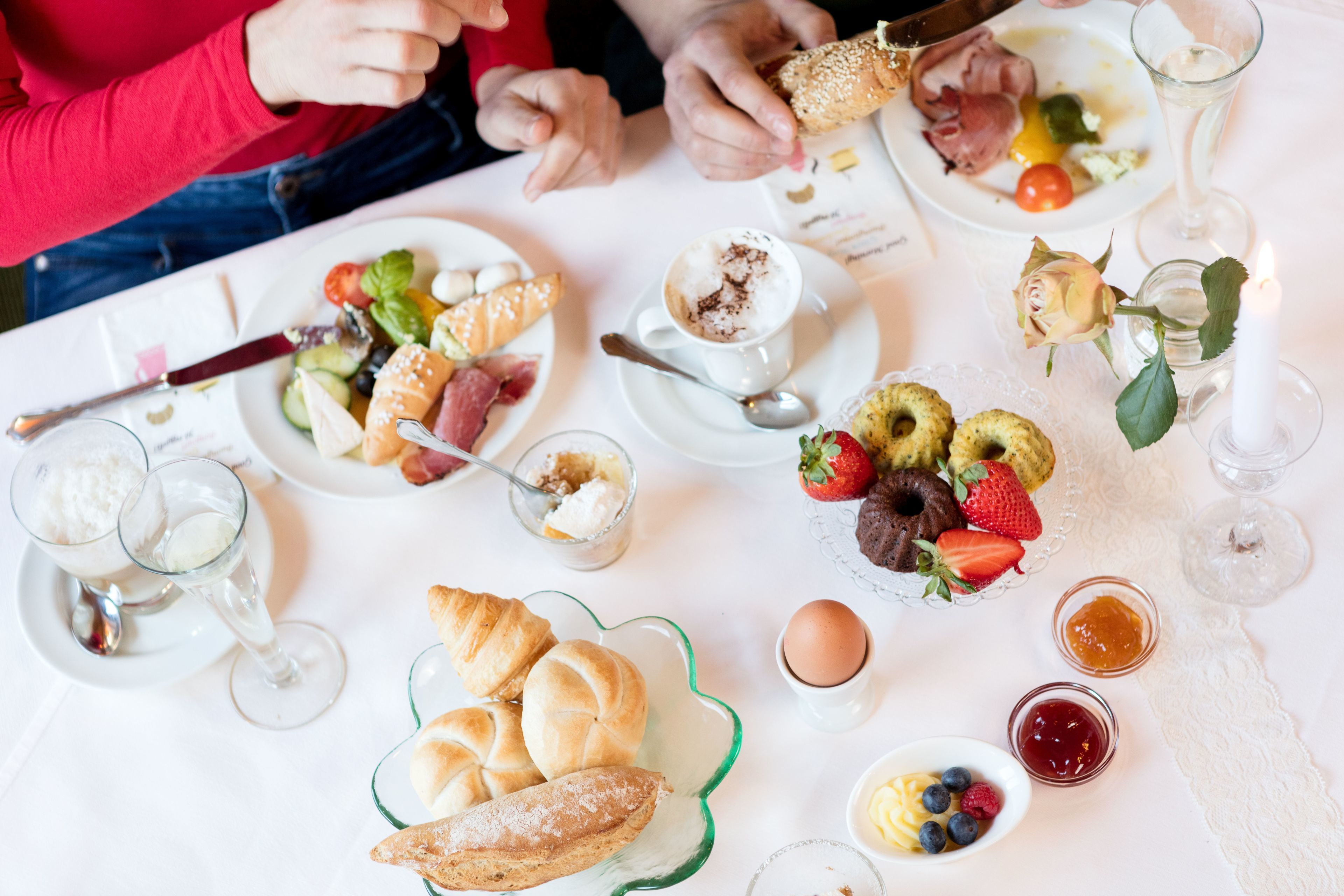 A table set with various breakfast items including pastries, fruits, and beverages.